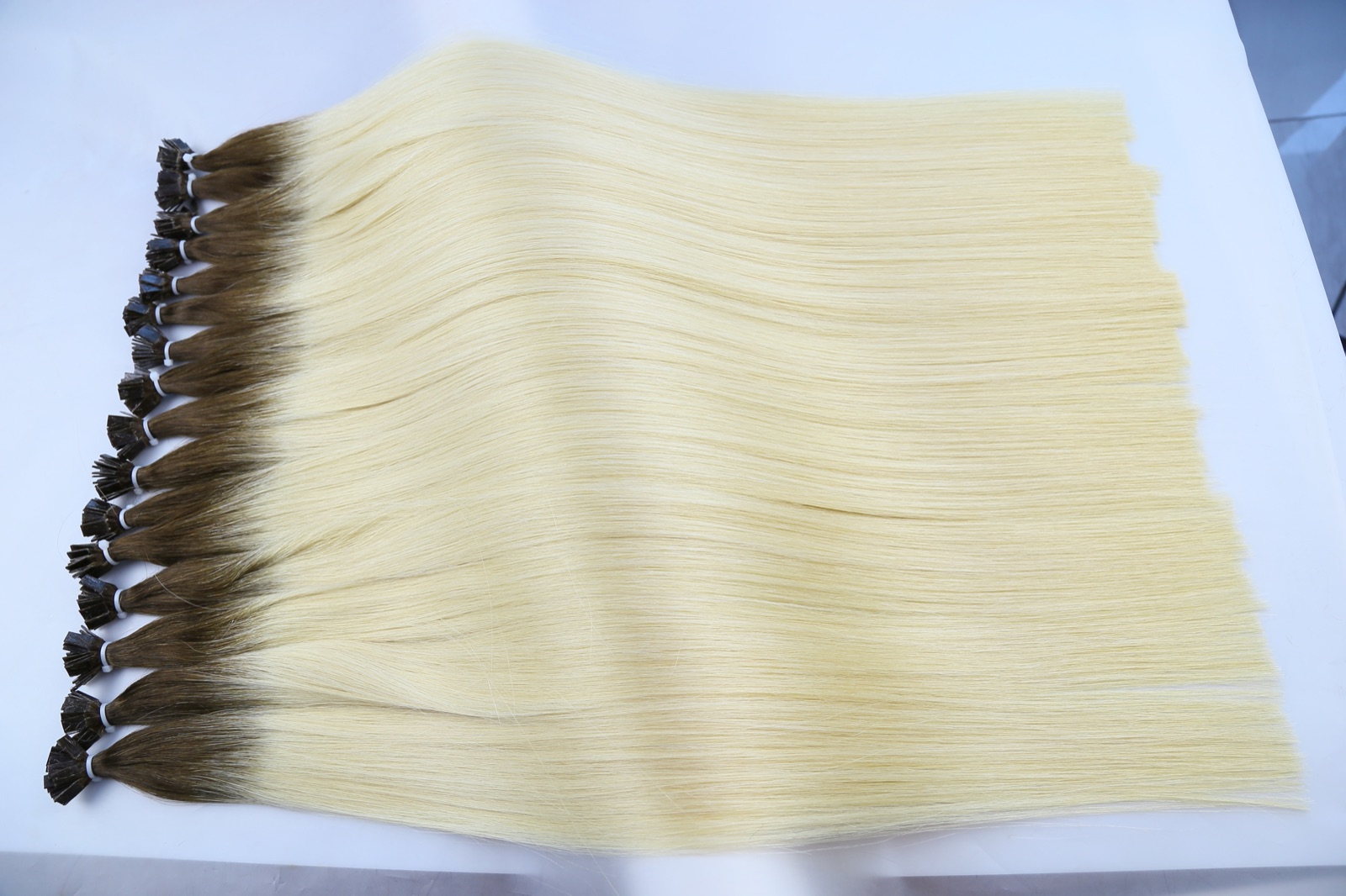 Rooted blonde Flat Tip hair extensions with visible flat keratin tips